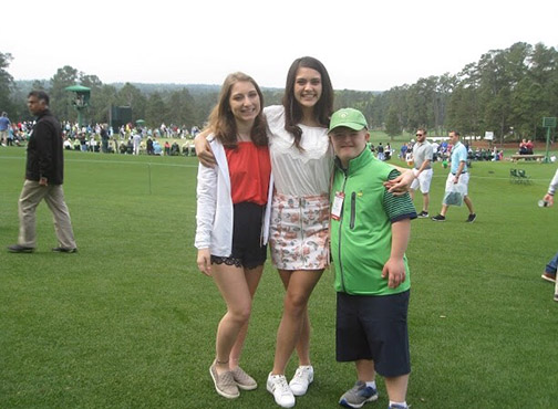 Junior greets golf fans at Masters Tournament at Augusta